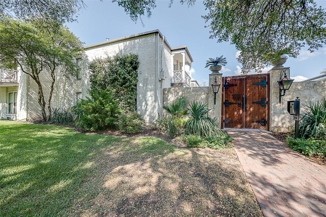 view of side of property with a lawn