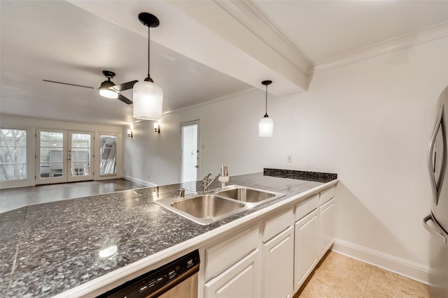 kitchen with ornamental molding, stainless steel appliances, pendant lighting, sink, and white cabinets