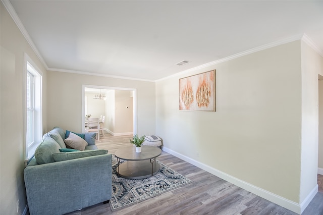 living room with hardwood / wood-style flooring, plenty of natural light, and crown molding