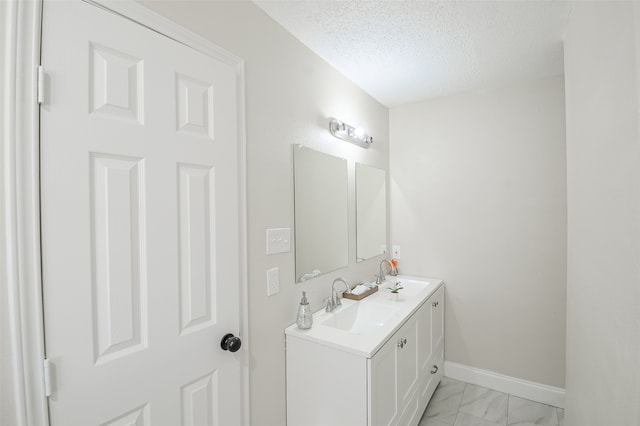 bathroom featuring vanity and a textured ceiling