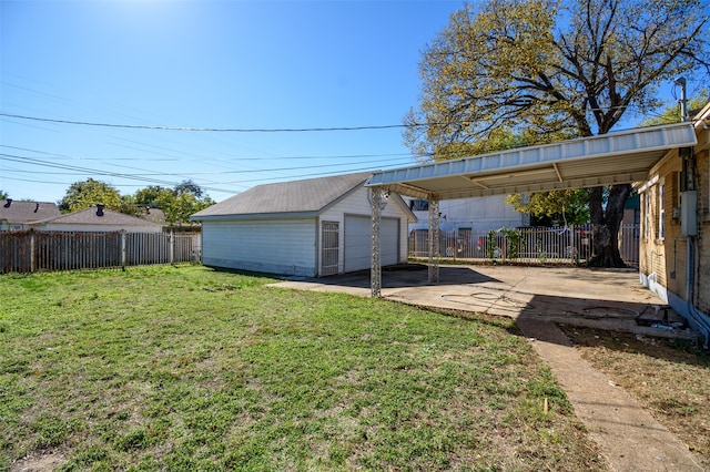 view of yard with an outbuilding, a garage, and a carport