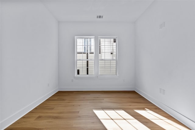 spare room with light hardwood / wood-style flooring