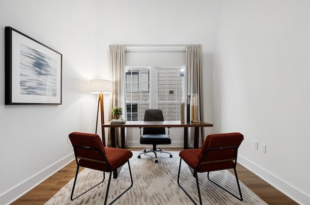 home office featuring baseboards and wood finished floors