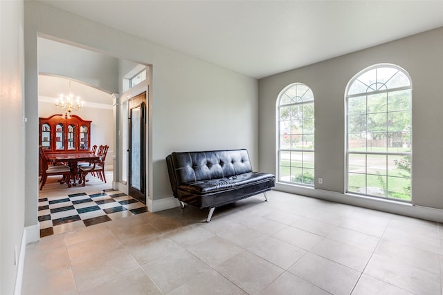 sitting room featuring a notable chandelier, a healthy amount of sunlight, and light tile patterned flooring