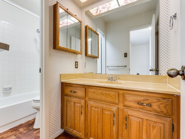 full bathroom with bathing tub / shower combination, vanity, parquet floors, and toilet