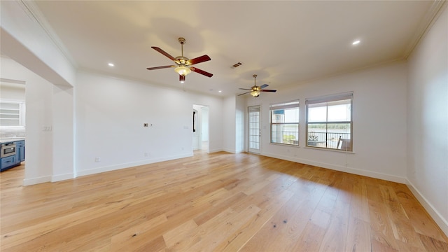 unfurnished living room with crown molding and light hardwood / wood-style floors