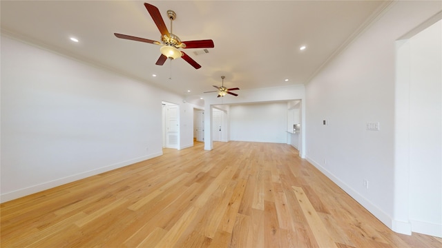 unfurnished living room featuring ornamental molding and light wood-type flooring