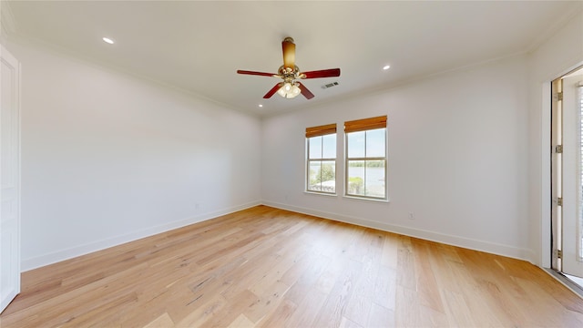 spare room with ceiling fan, ornamental molding, and light hardwood / wood-style flooring