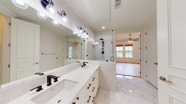 bathroom with an enclosed shower, vanity, ornamental molding, and ceiling fan