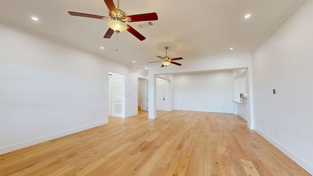 unfurnished living room with ornamental molding and light wood-type flooring