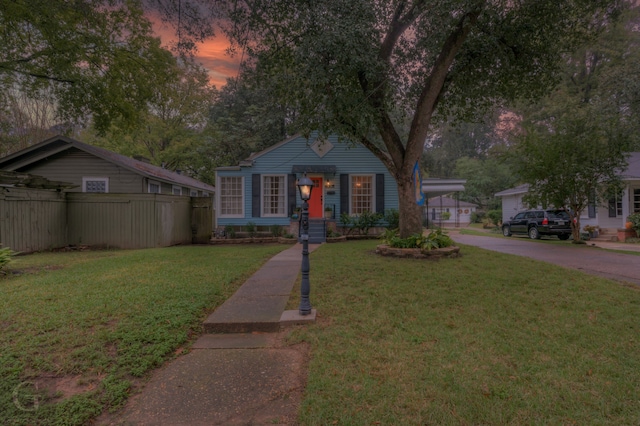 view of front of home featuring a garage and a yard