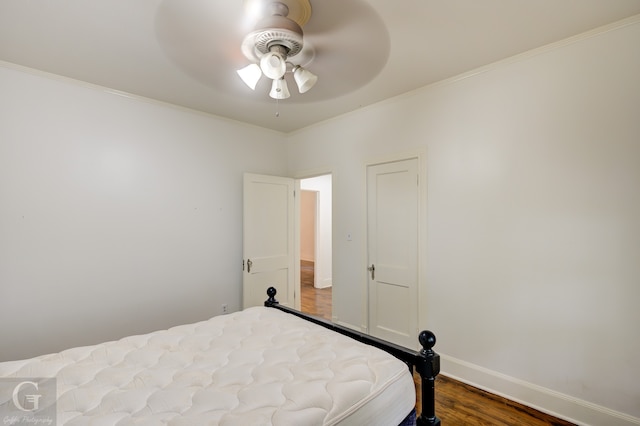 bedroom with wood-type flooring, ceiling fan, and crown molding