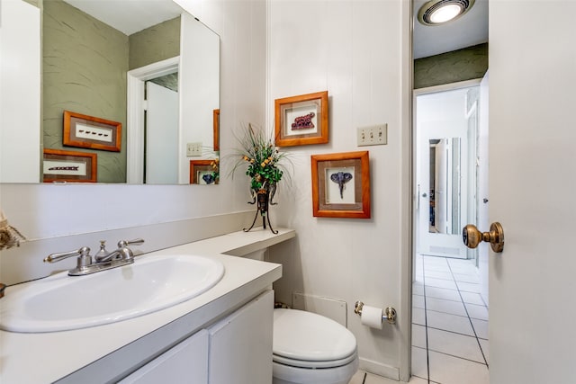 bathroom featuring toilet, vanity, and tile patterned flooring