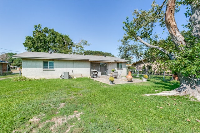 rear view of property featuring central AC unit, a patio, and a yard