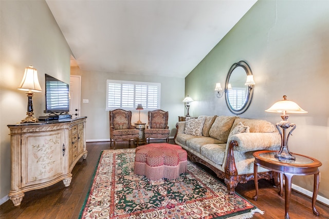 living room with dark wood-type flooring and vaulted ceiling