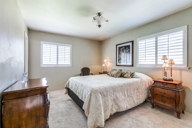 carpeted bedroom featuring multiple windows