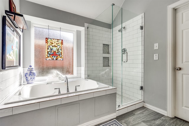 bathroom featuring shower with separate bathtub