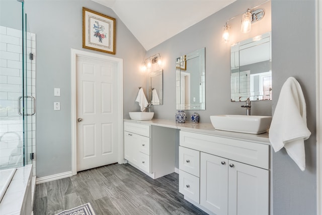 bathroom with hardwood / wood-style floors, vanity, walk in shower, and lofted ceiling