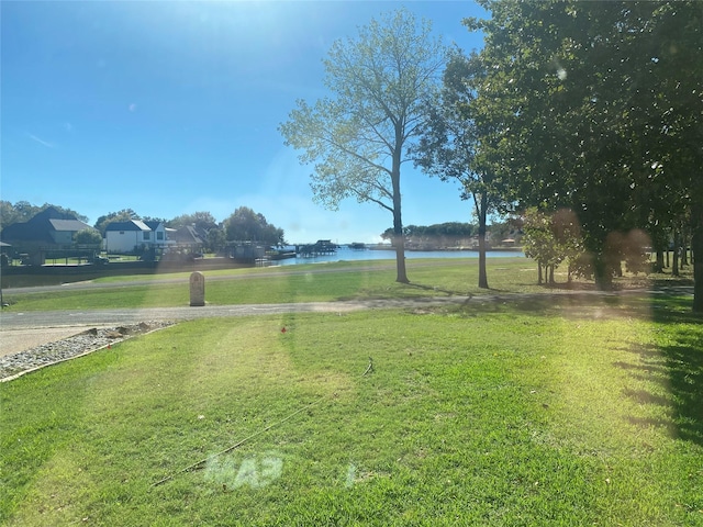 unfurnished sunroom featuring plenty of natural light, ceiling fan, and a water view