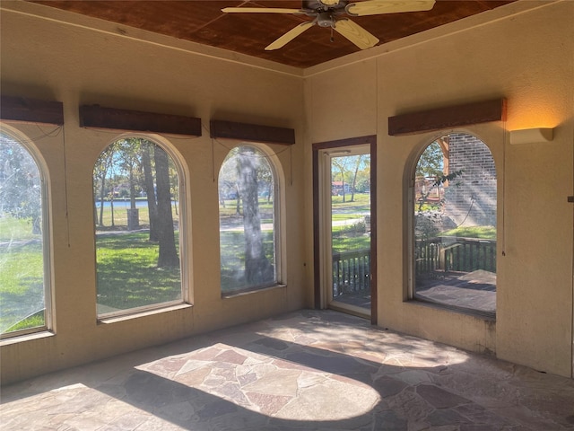 view of patio featuring ceiling fan and a fireplace