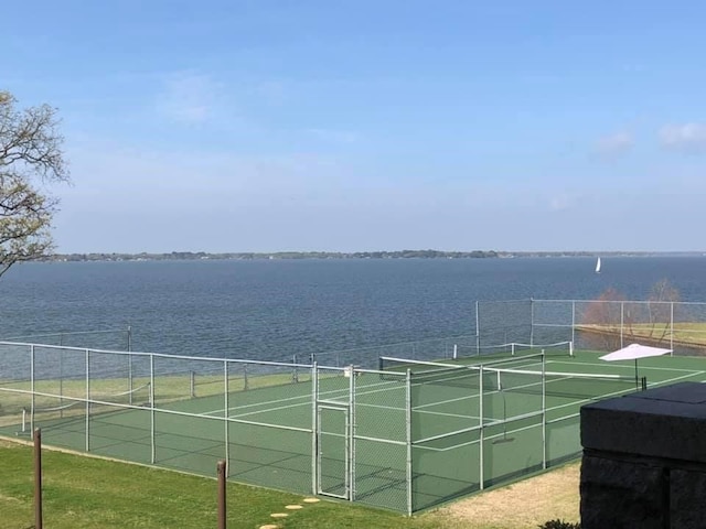 view of sport court with a water view