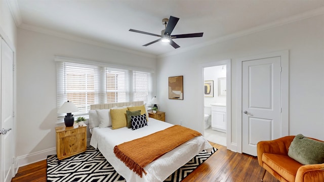 bedroom featuring crown molding, hardwood / wood-style floors, ceiling fan, and ensuite bath