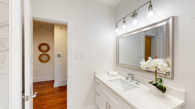 bathroom with hardwood / wood-style floors and vanity