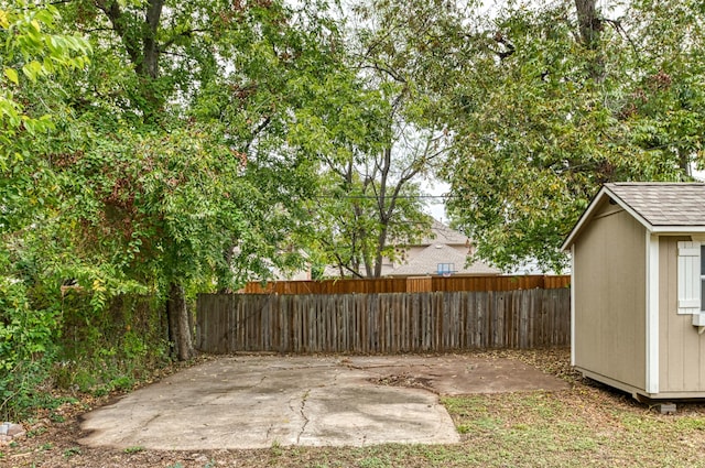 view of yard with a shed and a patio area