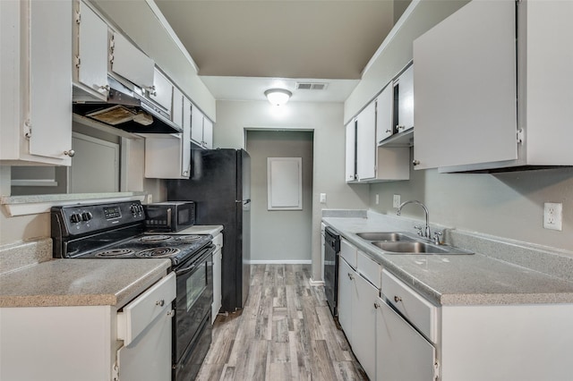 kitchen featuring white cabinets, sink, light hardwood / wood-style flooring, and black appliances