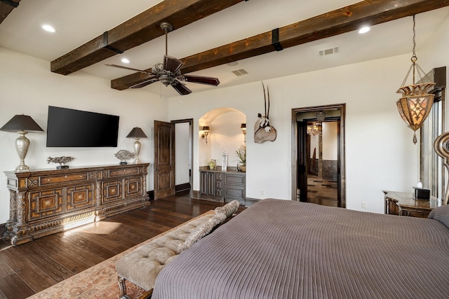 bedroom featuring dark hardwood / wood-style flooring and beam ceiling