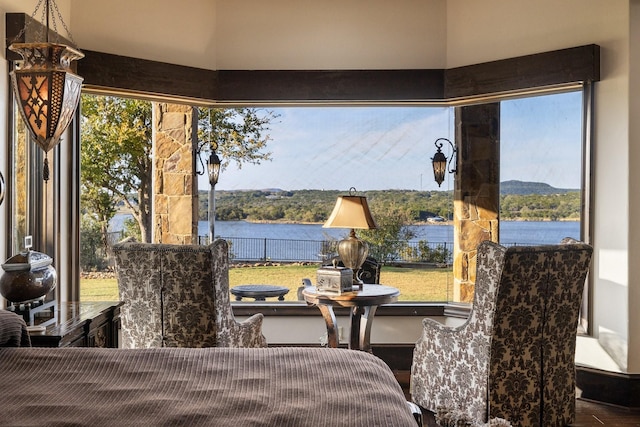 sunroom / solarium featuring a water view