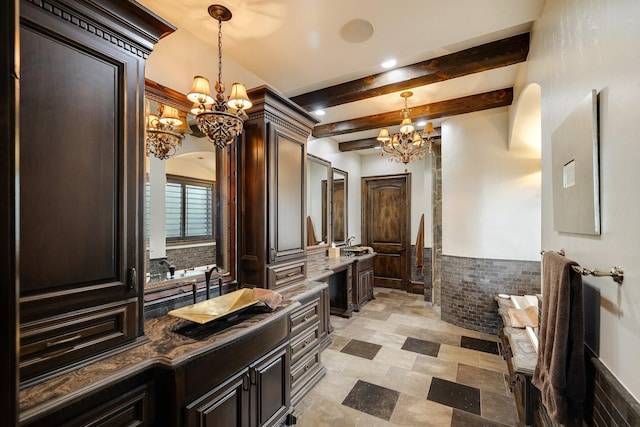 bathroom with vanity, beamed ceiling, and a chandelier