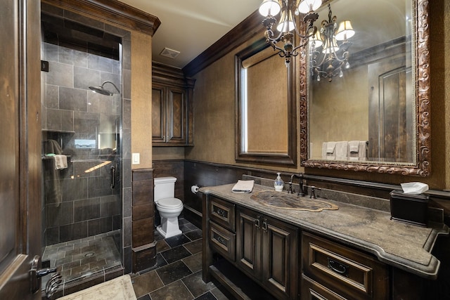 bathroom with crown molding, an inviting chandelier, an enclosed shower, vanity, and toilet