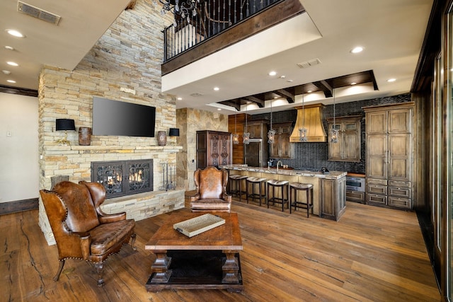 living room featuring dark hardwood / wood-style flooring, sink, and a fireplace