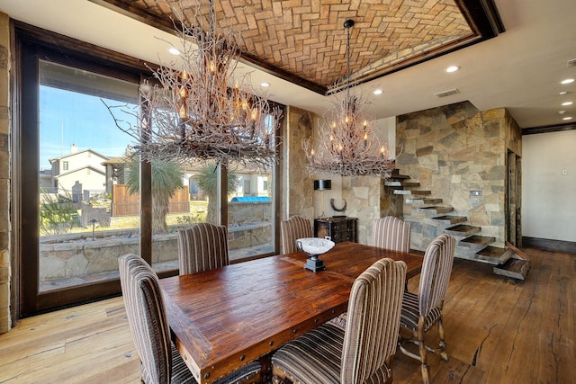 dining area featuring brick ceiling and light wood-type flooring