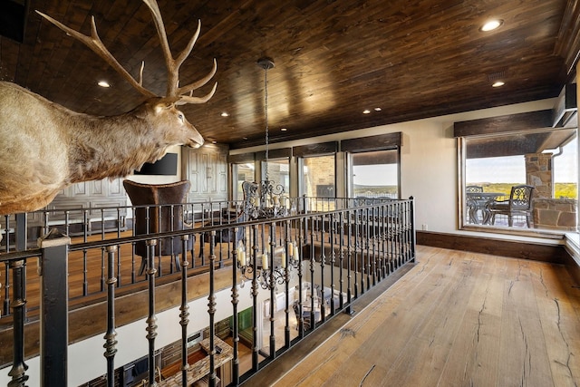 corridor with hardwood / wood-style floors and wooden ceiling