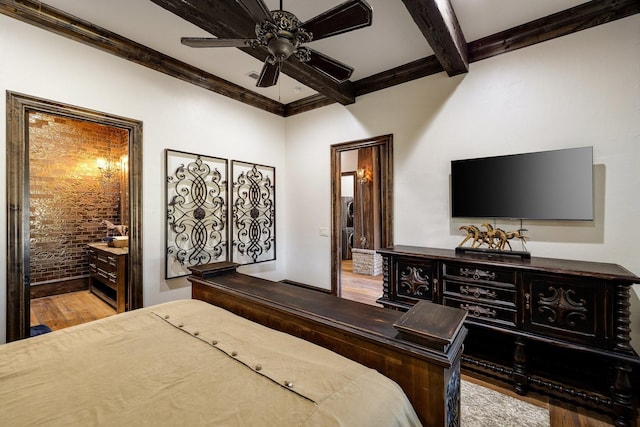 bedroom featuring crown molding, ensuite bath, beamed ceiling, brick wall, and light hardwood / wood-style floors