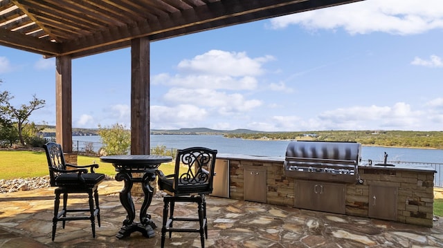 view of patio / terrace featuring a water view, area for grilling, and a pergola