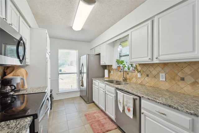 kitchen with white cabinetry, sink, plenty of natural light, and appliances with stainless steel finishes