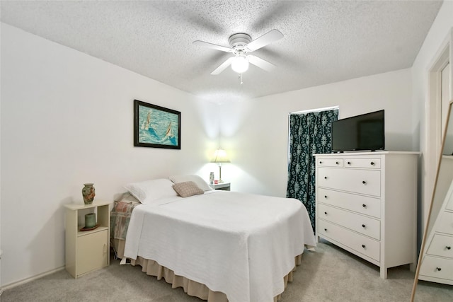 carpeted bedroom with a textured ceiling and ceiling fan