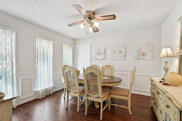 dining room with a textured ceiling, dark hardwood / wood-style flooring, and ceiling fan