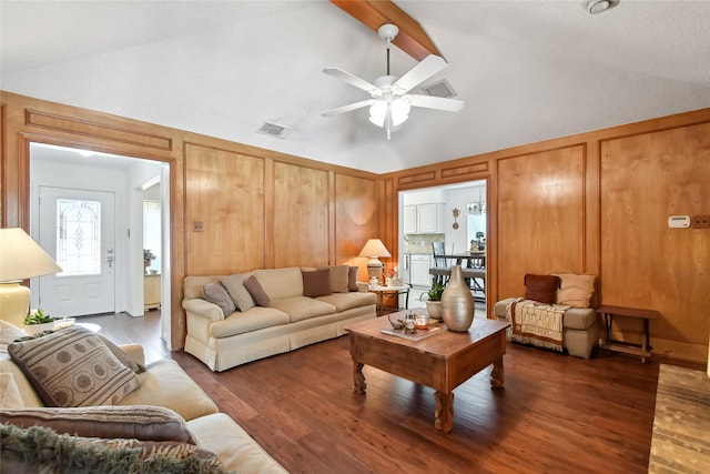 living room featuring dark hardwood / wood-style flooring, vaulted ceiling with beams, and ceiling fan