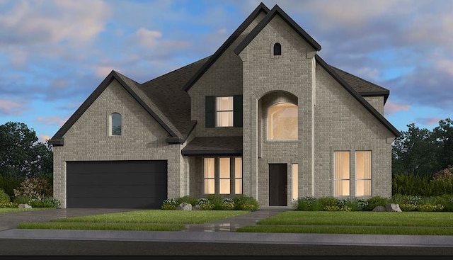 french provincial home featuring a lawn and a garage