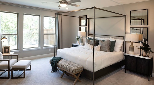 bedroom with ceiling fan and light colored carpet