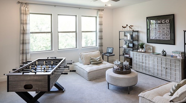 interior space featuring carpet, plenty of natural light, and ceiling fan