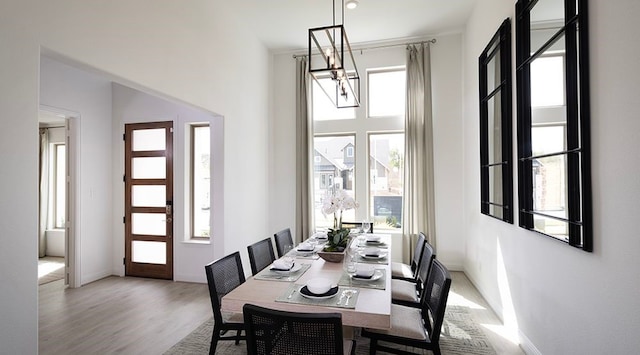 dining space featuring a chandelier, a wealth of natural light, and light hardwood / wood-style floors