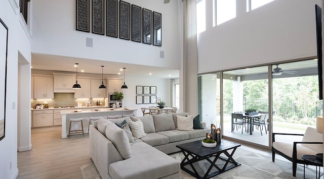 living room with plenty of natural light and a high ceiling