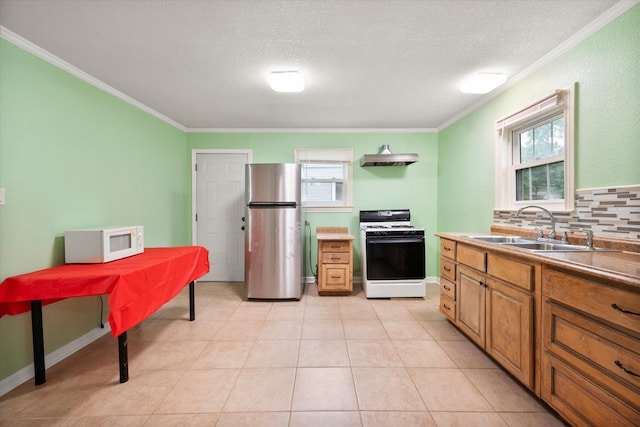 kitchen featuring backsplash, white appliances, sink, and ornamental molding