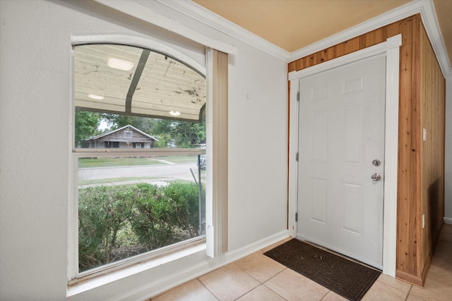 tiled foyer entrance featuring a healthy amount of sunlight and crown molding