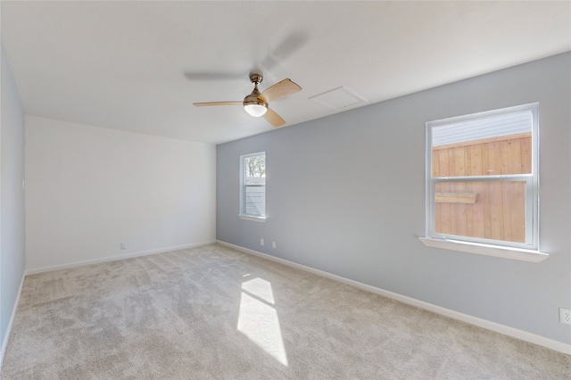 carpeted spare room featuring ceiling fan